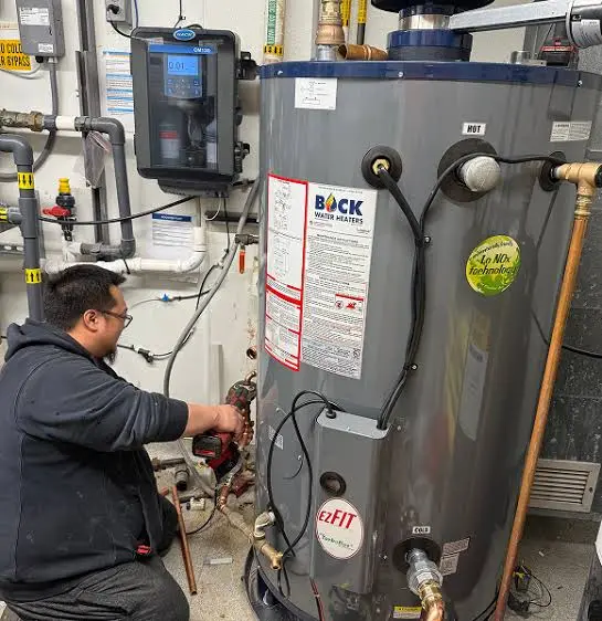 Licensed technician diagnosing a commercial water heater system in Nampa, Idaho