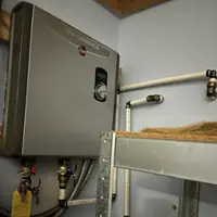 Technician installing a water heater in a Nampa, Idaho home