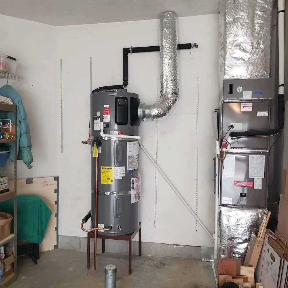 Licensed technician servicing a heat pump water heater in a Nampa, Idaho home