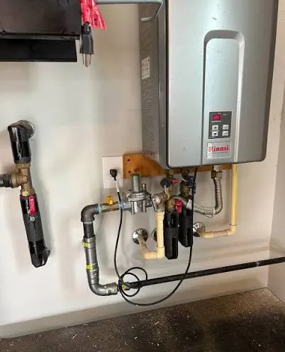 Plumber installing a tankless water heater in a Nampa, Idaho residential home