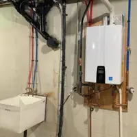 Plumber installing a tankless water heater in a Nampa, Idaho residential home