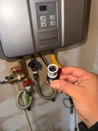 Technician diagnosing the cause of water heater noise in a Nampa, Idaho home
